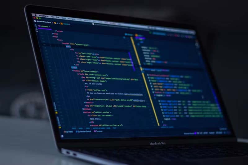Lines of colorful HTML code displayed on a dark computer monitor, showing the environment where alt attributes are written.