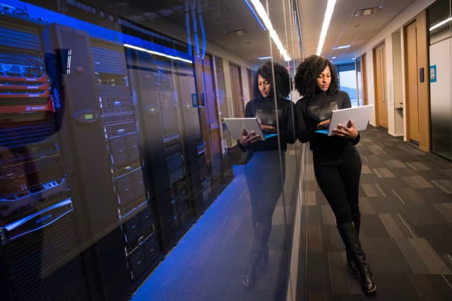 A woman in an office working on her laptop adding alt text to images